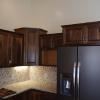 The cabinet next to the top of the refrigerator is designed for the microwave. While framing the house we left an opening in the wall studs for the back of this cabinet to recess into. The microwave part of the cabinet is 16 inches deep while the top of this cabinet is a standard 12 inches deep.