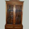 A cherry gun cabinet. The rack holding the guns is curved so that scoped riffles can fit in the middle section and the open sight guns go toward the ends. This was done to get the most guns in the least space and still keep the eye appeal.
