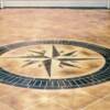 A cocrete driveway with a Compass Rose. Remember driveways see heavy traffic and salt, therefore they are high maintenance.