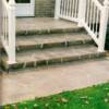 The original steps were pitted and spalled. We covered them with an overlay and stained them to look like aged limestone.