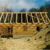 The same home after we set the logs and roof framing.